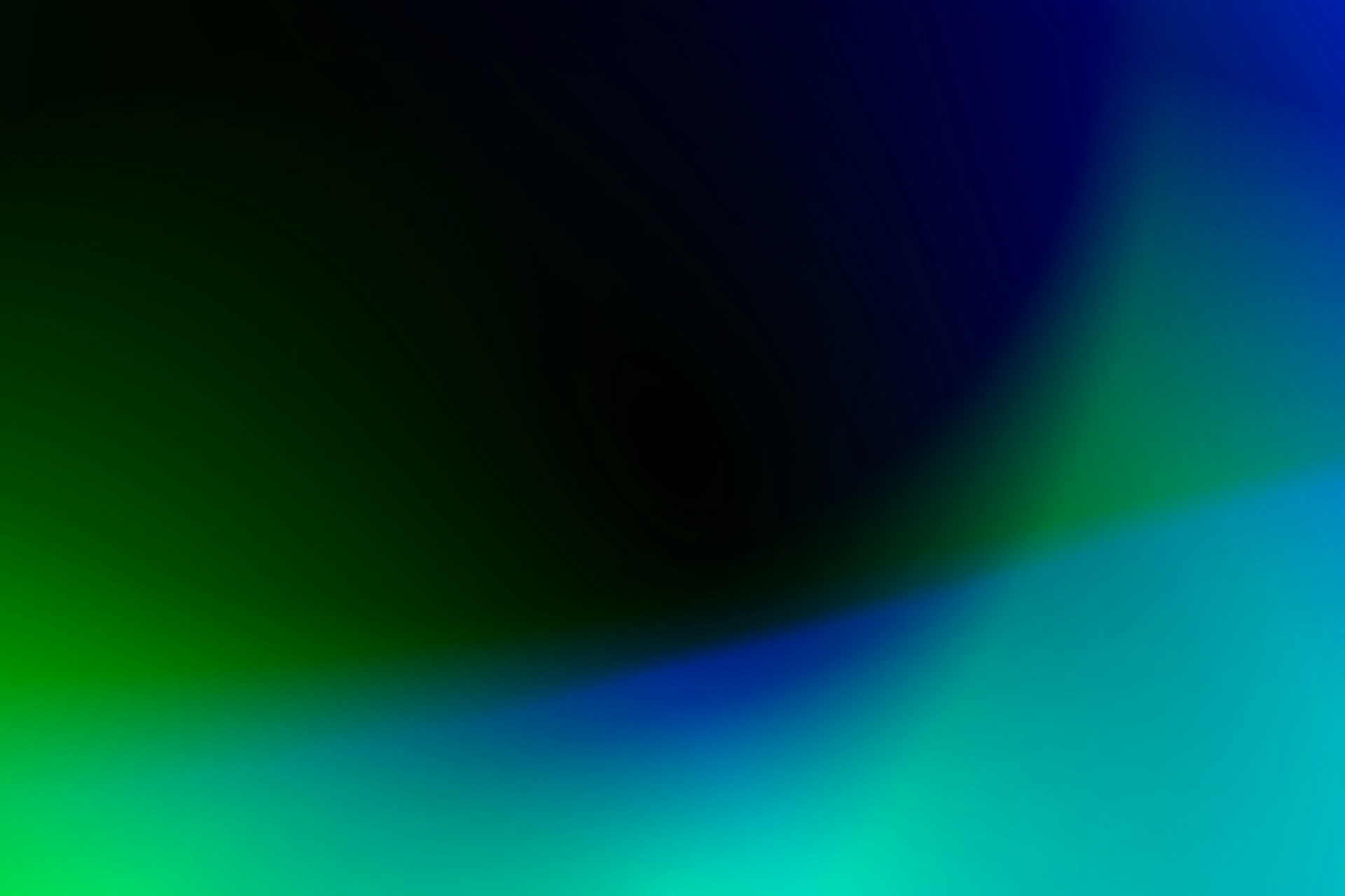 Abstract gradient of blue and green light on a dark background
